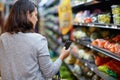 The smart way to shop. Cropped shot of a woman checking her digital shopping list on her cellphone in a grocery store. Royalty Free Stock Photo