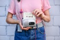 cropped shot of woman with earphones holding retro cassette player and audio cassette in hands against white Royalty Free Stock Photo