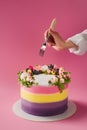 cropped shot of woman with fork and sweet cake decorated with flowers Royalty Free Stock Photo