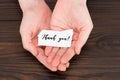 cropped shot of woman holding paper with thank you lettering