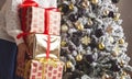 Woman with stack of Christmas gifts near xmas tree at home Royalty Free Stock Photo