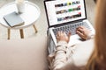 cropped shot of woman at home sitting on couch and using laptop with youtube website