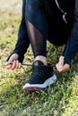 cropped shot of woman lacing sneakers while sitting Royalty Free Stock Photo