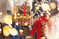 Cropped shot of woman and little boy holding stack of Xmas or New Year presents for family members and relatives while standing Royalty Free Stock Photo