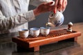 Woman pouring tea in traditional chinese teaware. Royalty Free Stock Photo