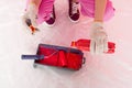 cropped shot of woman in protective gloves pouring red paint from bottle into roller tray Royalty Free Stock Photo