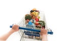 cropped shot of woman pushing shopping trolley with grocery bags and plastic bottle of water