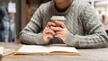 A cropped shot of a woman sipping coffee and working remotely at a cafe Royalty Free Stock Photo