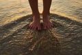 Keep calm and get your feet wet. Cropped shot of a woman standing with her feet in the water. Royalty Free Stock Photo