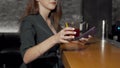 Cropped shot of a woman taking cocktail glass from bar counter