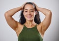 Its your hair, take care of it. Cropped shot of a woman touching her wet hair against a grey background. Royalty Free Stock Photo