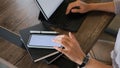 Cropped shot of woman using blank screen mobile phone and browsing internet on tablet computer . Royalty Free Stock Photo