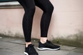 cropped shot of a woman wearing black leggings and sneakers