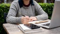 A cropped shot of a woman working on her business tasks at a table outdoors Royalty Free Stock Photo