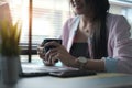 Cropped shot of a young businesswoman hands holding coffee cup while sitting in front of laptop. Royalty Free Stock Photo