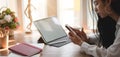 Cropped shot of young businesswoman working on her project while using smartphone in comfortable office Royalty Free Stock Photo