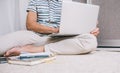 Cropped shot of young European man in stylish shirt sitting on the floor at home with laptop pc on his lap, surfing on Internet Royalty Free Stock Photo