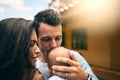My pride and joy. Cropped shot of a young father kissing his infant son while standing outside with this wife. Royalty Free Stock Photo