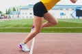 Cropped shot of young female athlete launching off the start line in a race. Female runner started the sprint from the Royalty Free Stock Photo