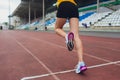 Cropped shot of young female athlete launching off the start line in a race. Female runner started the sprint from the Royalty Free Stock Photo