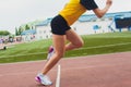 Cropped shot of young female athlete launching off the start line in a race. Female runner started the sprint from the Royalty Free Stock Photo