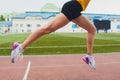 Cropped shot of young female athlete launching off the start line in a race. Female runner started the sprint from the Royalty Free Stock Photo