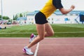 Cropped shot of young female athlete launching off the start line in a race. Female runner started the sprint from the Royalty Free Stock Photo