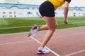 Cropped shot of young female athlete launching off the start line in a race. Female runner started the sprint from the Royalty Free Stock Photo