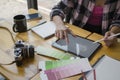 Young female graphic designer holding stylus pen and working with digital tablet at creative office. Royalty Free Stock Photo