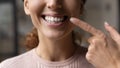 Cropped shot of young female pointing finger on hollywood smile Royalty Free Stock Photo