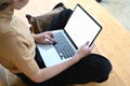 Cropped shot of young male freelancer working on her project with blank screen laptop. Royalty Free Stock Photo