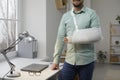 Cropped shot of young man with broken arm in cast Royalty Free Stock Photo