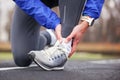 Cropped shot of a young man holding his ankle in pain sprain a f Royalty Free Stock Photo