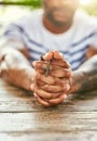 True to his religion. Cropped shot of a young man holding his rosary while praying. Royalty Free Stock Photo