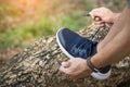 Cropped shot of young man runner tightening running shoe laces, Royalty Free Stock Photo