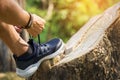 Cropped shot of young man runner tightening running shoe laces, Royalty Free Stock Photo