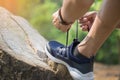 Cropped shot of young man runner tightening running shoe laces, Royalty Free Stock Photo