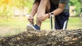 Cropped shot of young man runner tightening running shoe laces, Royalty Free Stock Photo