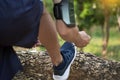 Cropped shot of young man runner tightening running shoe laces, Royalty Free Stock Photo