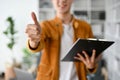 Cropped shot of young man showing a thumbs up symbol to the camera Royalty Free Stock Photo