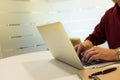 cropped shot of a young man working from home using laptop computer, man at his workplace using technology Royalty Free Stock Photo