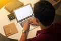 cropped shot of a young man working from home using laptop computer, man at his workplace using technology Royalty Free Stock Photo