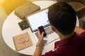 Cropped shot of a young man working from home using smart phone Royalty Free Stock Photo