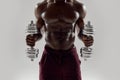 Cropped shot of young muscular african american man lifting weights, standing isolated over grey background. Sports Royalty Free Stock Photo