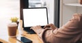 Cropped shot of young professional businesswoman typing on blank screen tablet and office supplies in simple workspace. Royalty Free Stock Photo