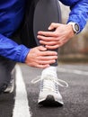 Cropped shot of a young runner holding his leg in pain. Royalty Free Stock Photo