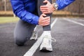 Cropped shot of a young runner holding his leg in pain. Royalty Free Stock Photo