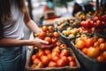 cropped shot of a young woman buying tomatoes from a farmers market