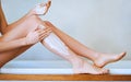 Get ready for a leggy day. Cropped shot of a young woman shaving her legs in the bathroom. Royalty Free Stock Photo