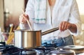 Dinner is almost ready. Cropped shot of a young woman stirring a pot in her kitchen at home. Royalty Free Stock Photo